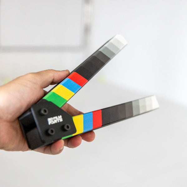 SNAPMARK Clapper Sticks held open in one hand, showing handheld scale