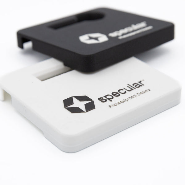 Black and white Profoto B10 battery covers stacked, showing UV printed logos on both colours