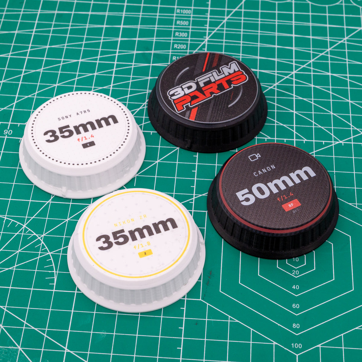 A mix of custom UV-printed lens caps with full-colour logos on 3D-printed film parts